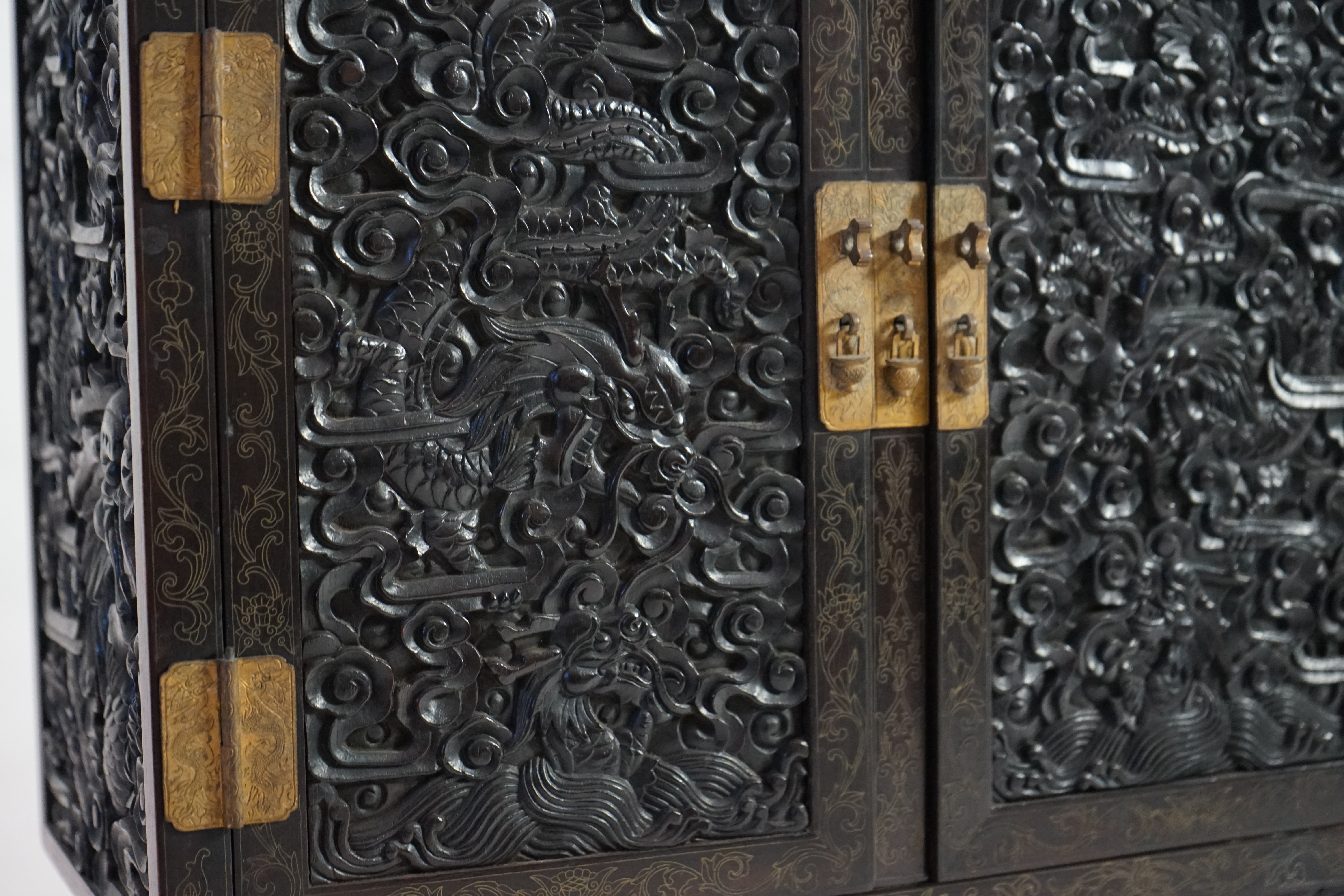 An important pair of Chinese carved zitan and silver wire inlaid ‘cloud and dragon’ curio cabinets and stands, duobaoge, probably Imperial, late Qing dynasty